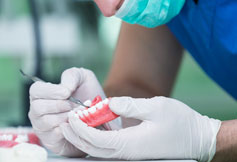 Dentist working on dentures